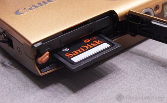 Cạnh dưới máy là khoang chứa pin sạc Li-ion Battery NB-11L và  khe cắm mở rộng hỗ trợ thẻ nhớ SD, SDHC và SDXC